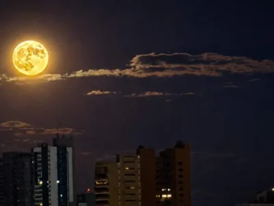 Lua dos Veados alaranjada encanta céu de Campo Grande